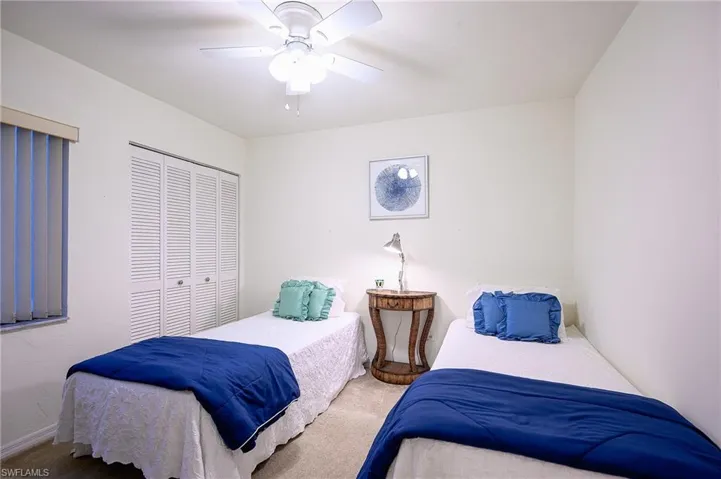 Bedroom with carpet floors, ceiling fan, and a closet
