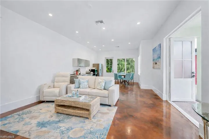 Living room featuring concrete floors and recessed lighting