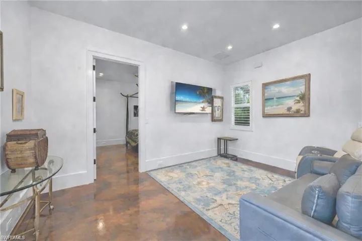 Living room with concrete floors and recessed lighting
