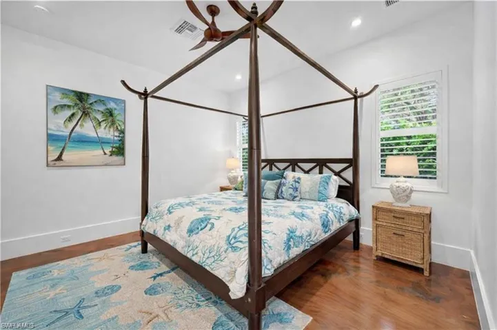 Bedroom with ceiling fan, wood finished floors, and recessed lighting