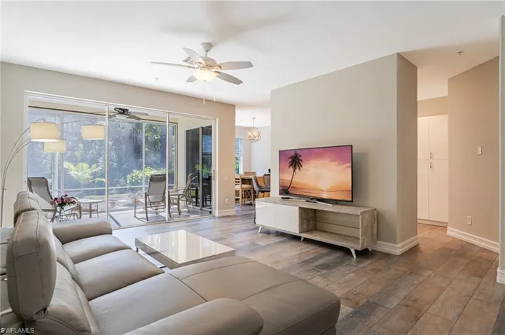 Living Room is light and bright walks out to lanai on a private preserve