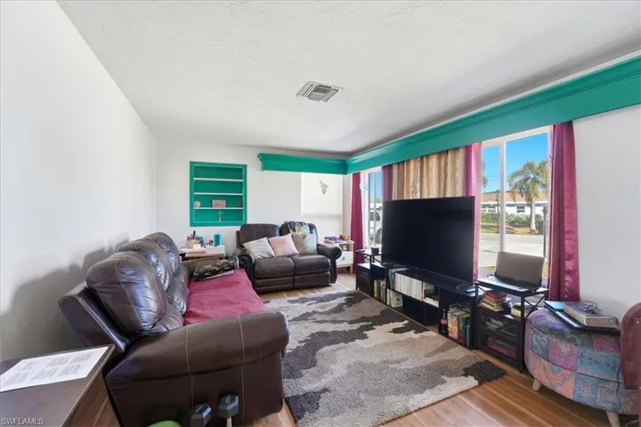 Living room with wood finished floors and a textured ceiling