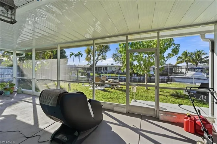 Sunroom featuring a water view