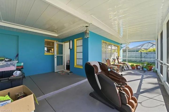 View of patio featuring a sunroom