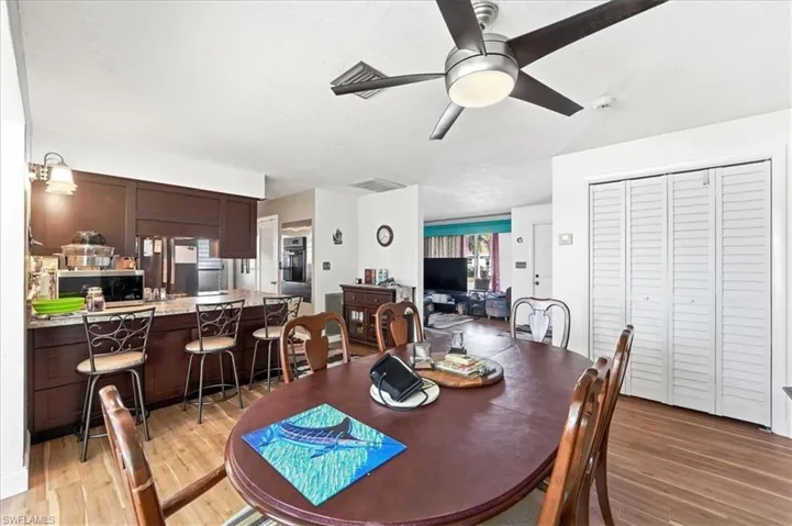 Dining space featuring light wood-style flooring and ceiling fan