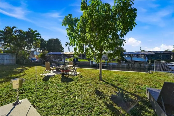 View of yard featuring a water view, a patio area, and an outdoor fire pit