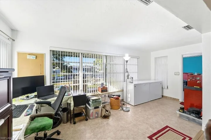 Office with light tile patterned floors