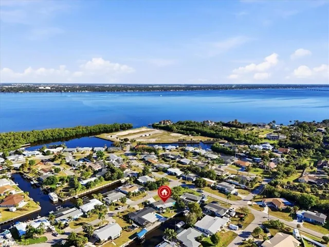 Aerial view of residential area featuring a nearby body of water