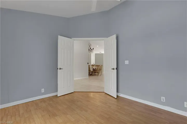 Empty room featuring baseboards and light wood-style flooring