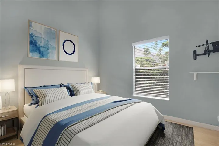 Bedroom featuring light wood-style flooring and natural lighting.