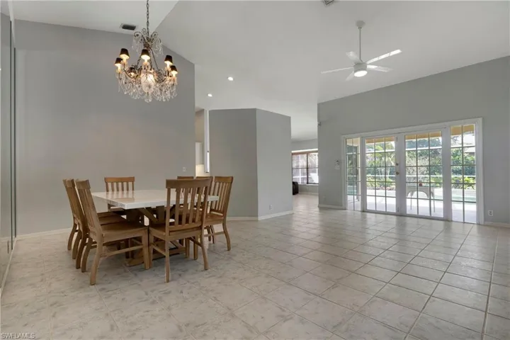 Dining area with baseboards, a chandelier, ceiling fan, recessed lighting, and light tile patterned floors