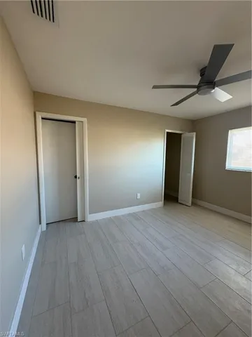 Unfurnished bedroom with a closet and a ceiling fan Features doorway to the guest bathroom