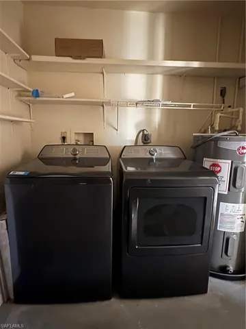 Laundry area with water heater and washing machine and dryer
