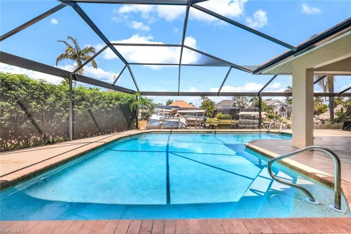 View of pool with glass enclosure
