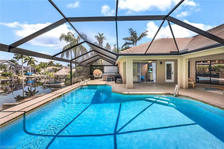 View of pool with ceiling fan, a lanai, and a patio area