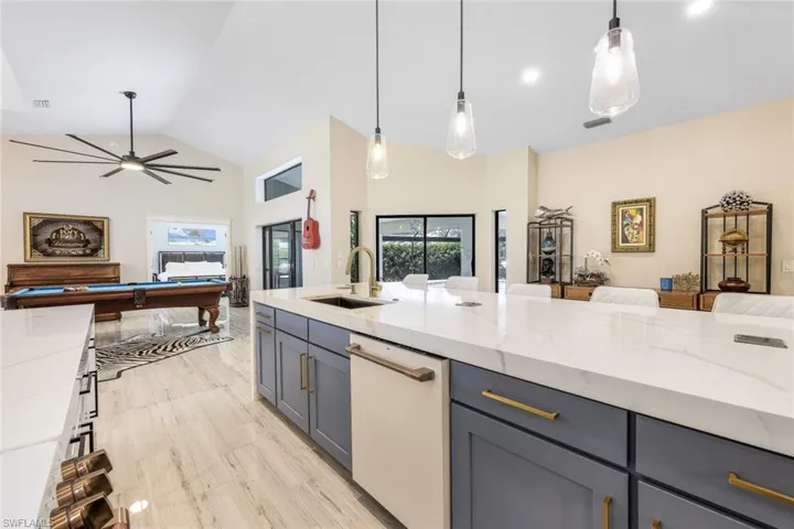 Kitchen featuring decorative light fixtures, billiards, and plenty of natural light