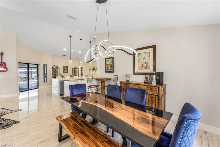 Dining room featuring light wood-type flooring and lofted ceiling