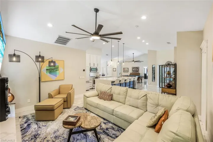 Living room featuring lofted ceiling and ceiling fan