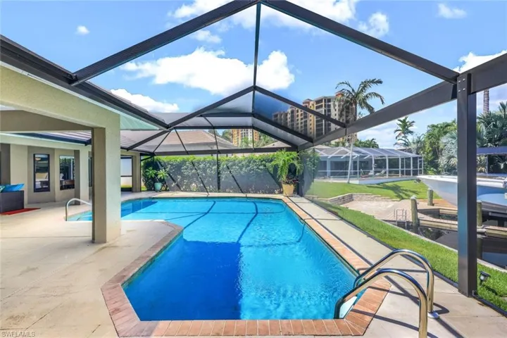 View of pool with a lanai and a patio area