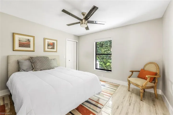 Bedroom with ceiling fan, a closet, and light hardwood / wood-style flooring