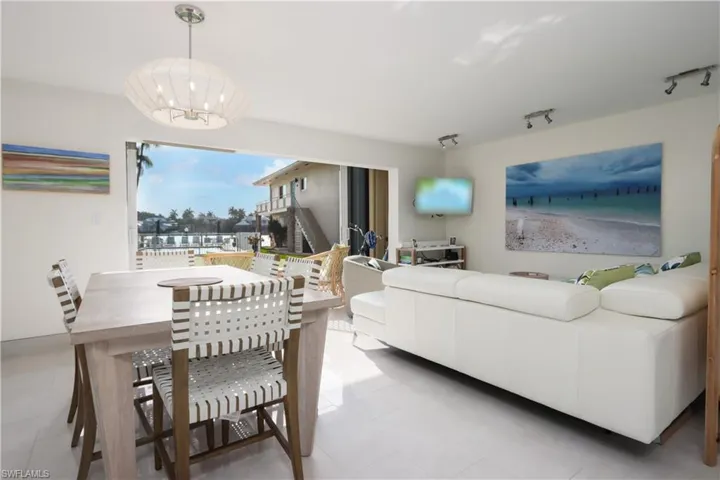 Living room featuring rail lighting and an inviting chandelier