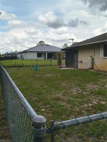 Expansive lawn with a chain-link perimeter fence