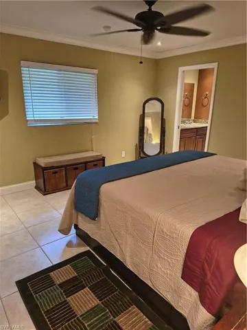 Spacious room featuring tile flooring, ceiling fan, crown molding, and recessed lighting