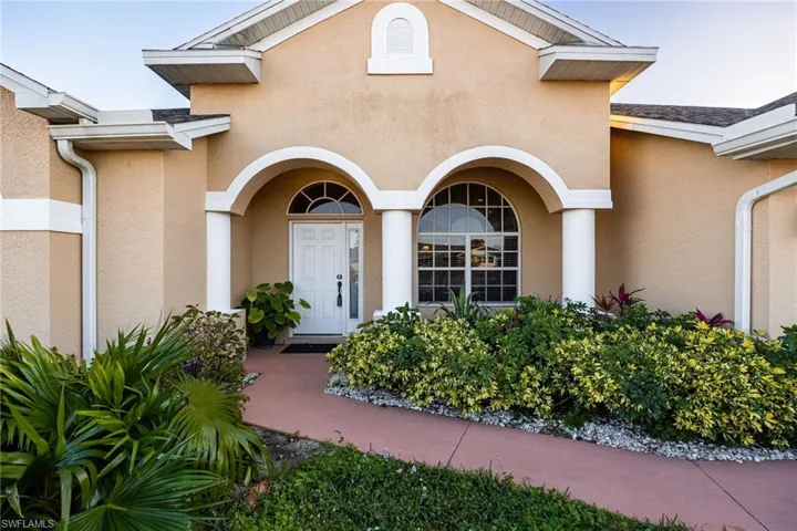 Doorway to property featuring stucco siding