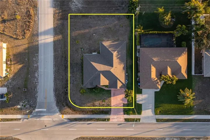 Aerial view of property and surrounding area with property boundaries highlighted