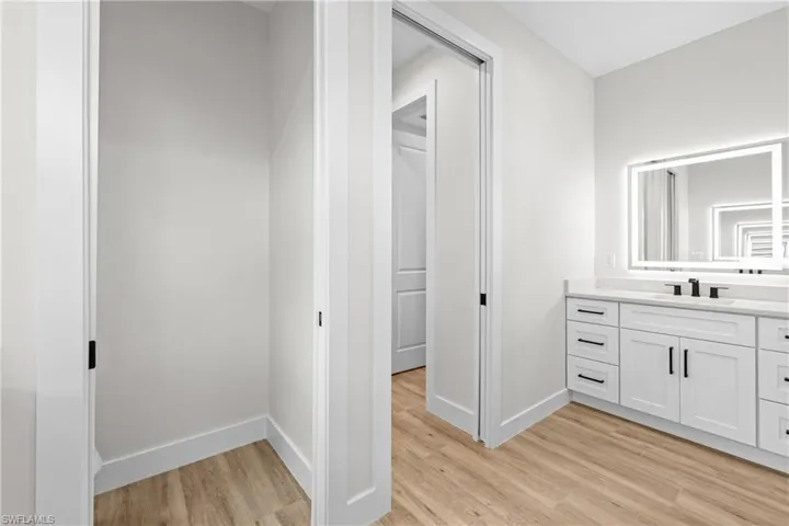 Master bathroom featuring dual vanities and separate toilet room