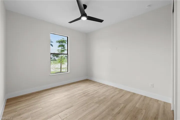 Guest Bedroom 1 featuring  ceiling fan
