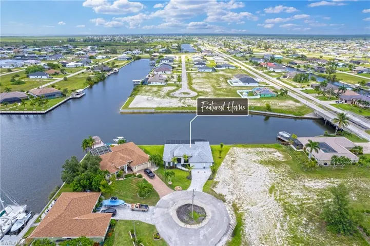 Birds eye view of property with a water view
