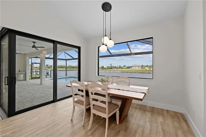 Dining space featuring ceiling fan and vaulted ceiling