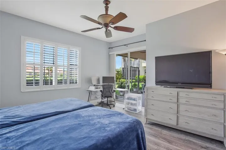 Bedroom with ceiling fan and hardwood / wood-style floors