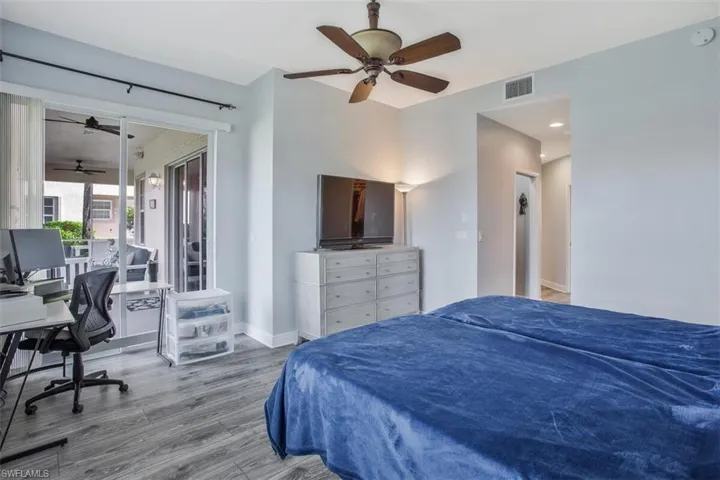 Bedroom with hardwood / wood-style floors and ceiling fan