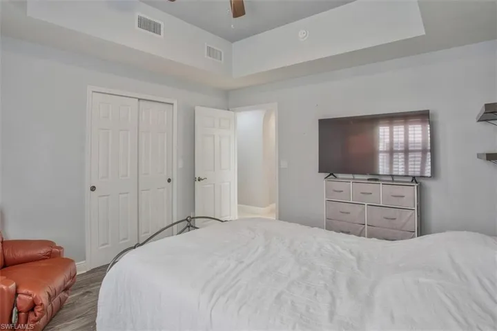 Bedroom with wood-type flooring, a closet, and ceiling fan