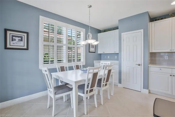 Tiled dining room with an inviting chandelier
