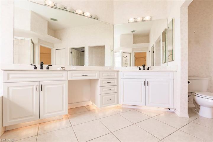 Owners suite has double vanities and under cabinet lighting.