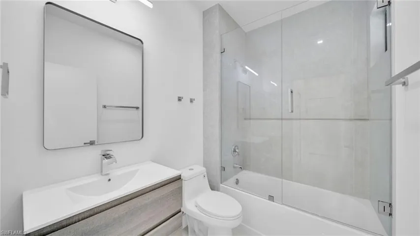 Full bath with vanity and enclosed tub / shower combo