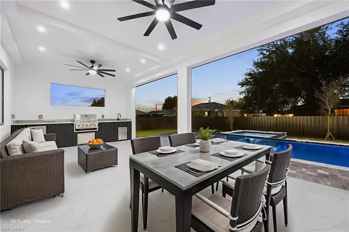 Fenced backyard with area for grilling, outdoor dining area, a patio area, ceiling fan, and outdoor lounge area