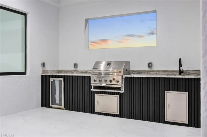 View of patio featuring an outdoor kitchen and wine cooler