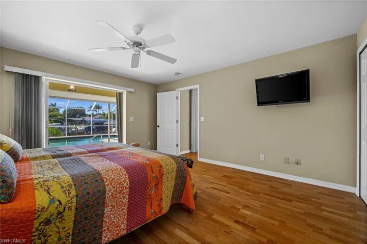 Primary bedroom with pool and water views