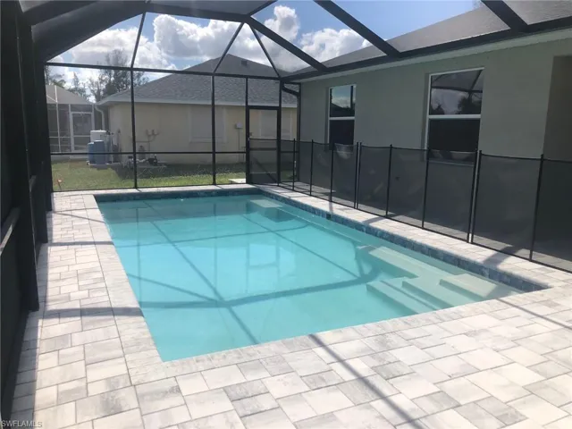 View of swimming pool with a lanai and a patio
