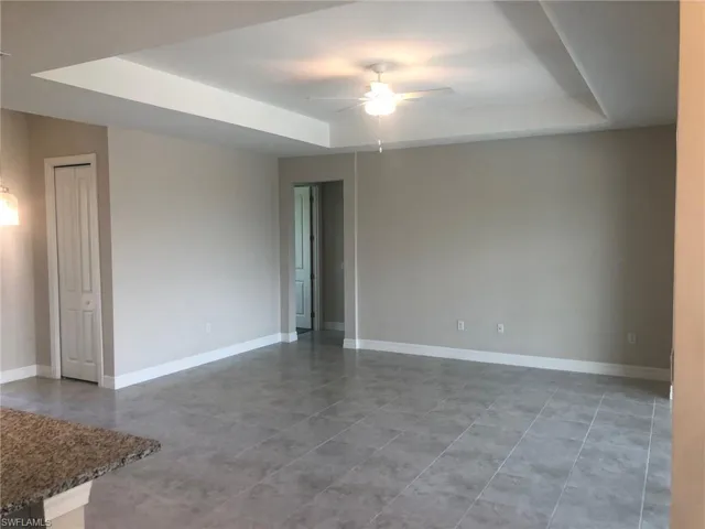 Spare room featuring ceiling fan and a raised ceiling