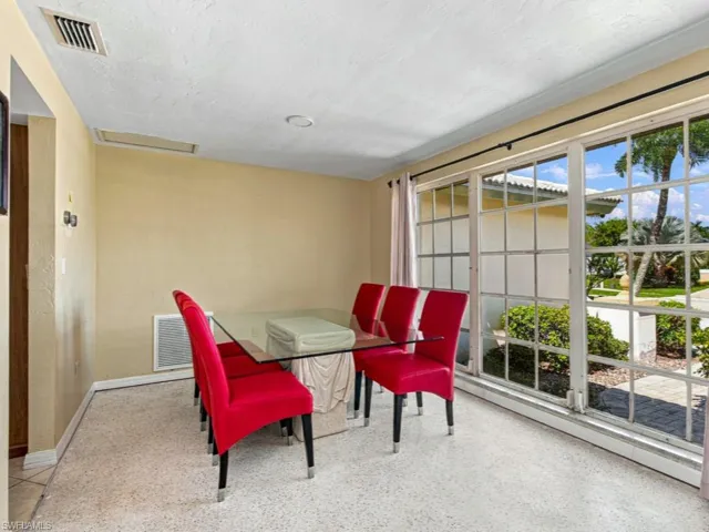 Terrazzo flooring, expansive grid-pane windows, and textured wall finish