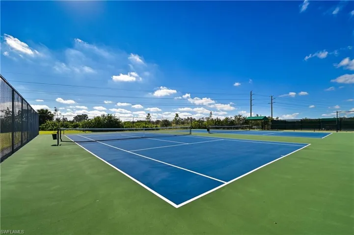 View of tennis court with community basketball court