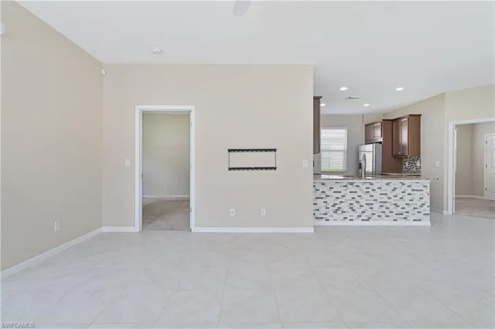 Unfurnished living room featuring light tile patterned flooring and recessed lighting