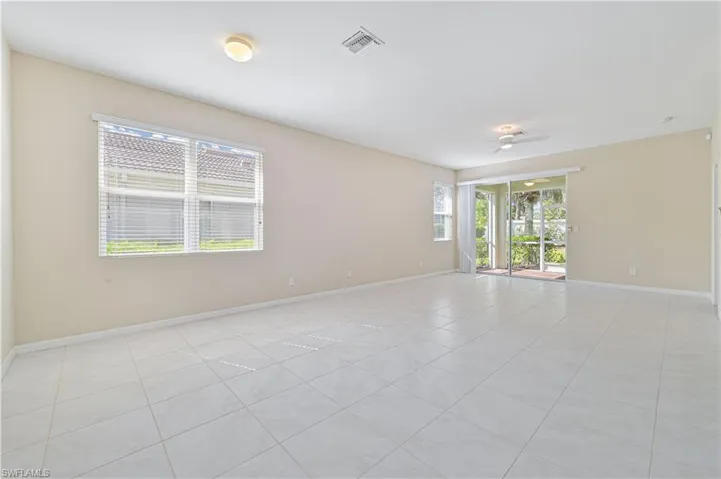 Empty room with light tile patterned flooring
