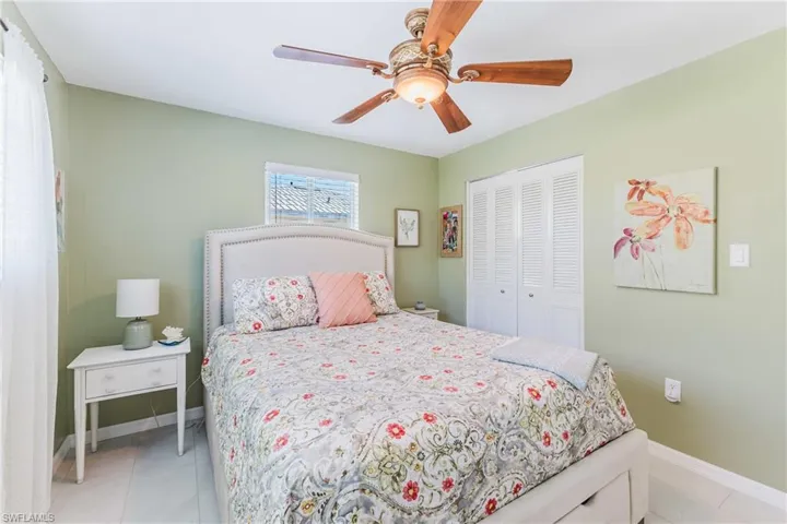 Bedroom with a ceiling fan, a closet, and light tile patterned floors