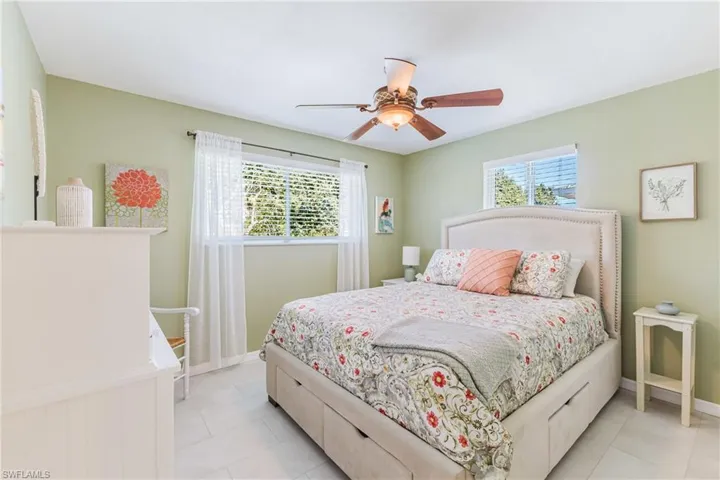 Bedroom featuring a ceiling fan and baseboards